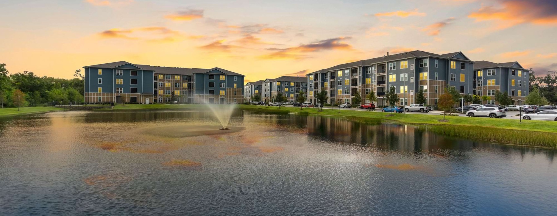 buildings by a body of water with a water fountain