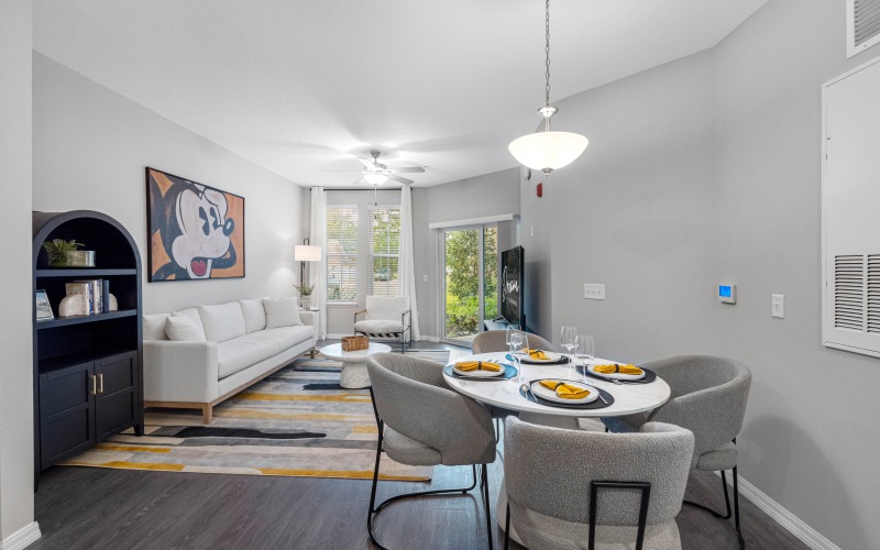 a living room with a tv table and chairs